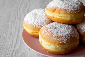 plate stacked with Sufganiyot (Fried Hanukkah Doughnuts)