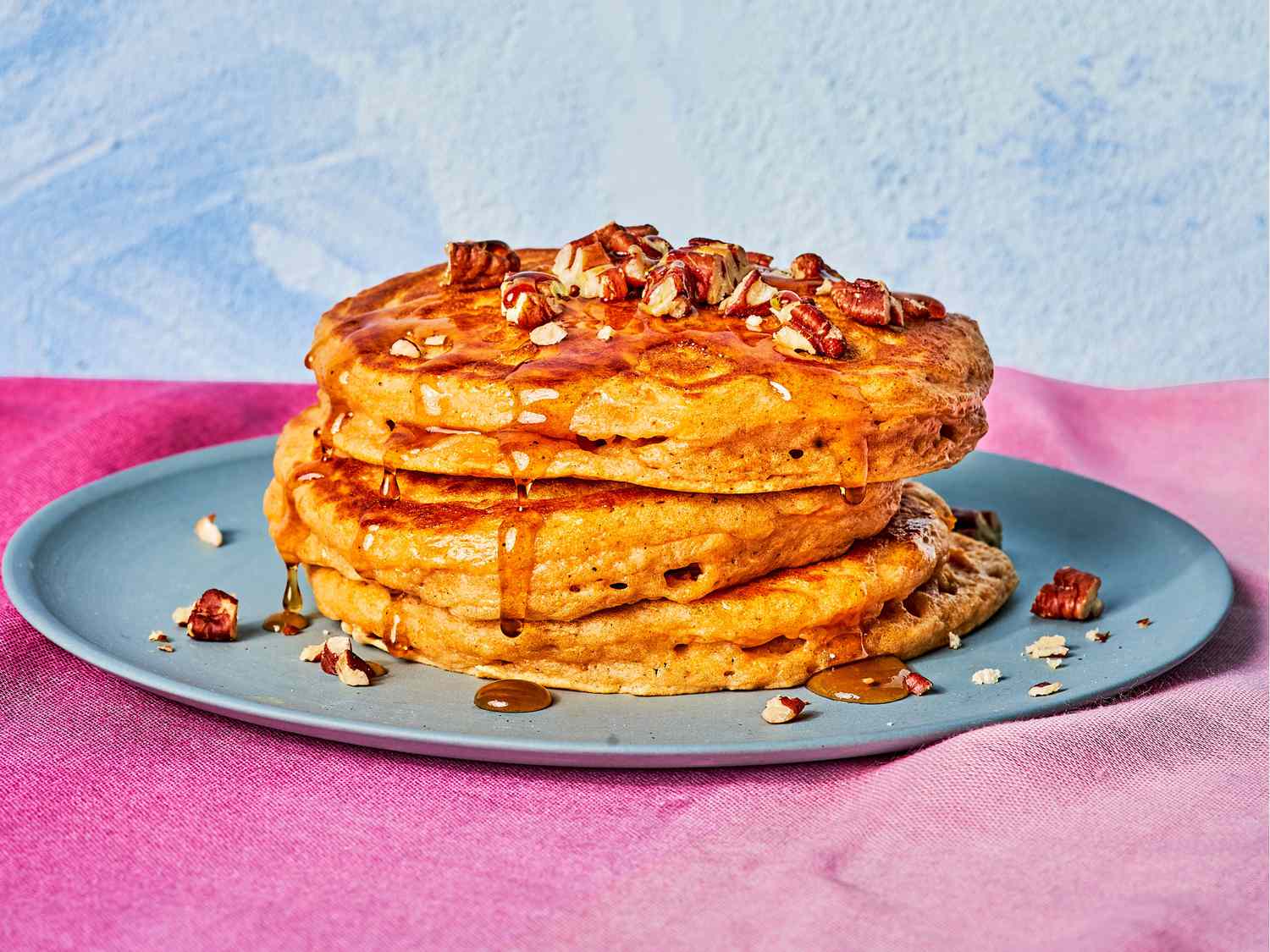 Stack of Three Sweet Potato Buttermilk Pancakes Topped With Syrup and Nuts