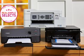 Best home printers displayed on wooden desk in front of window