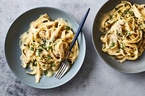 Fettucine With Vegan Cauliflower Alfredo Sauce, Served in Two Bowls With a Fork for Eating