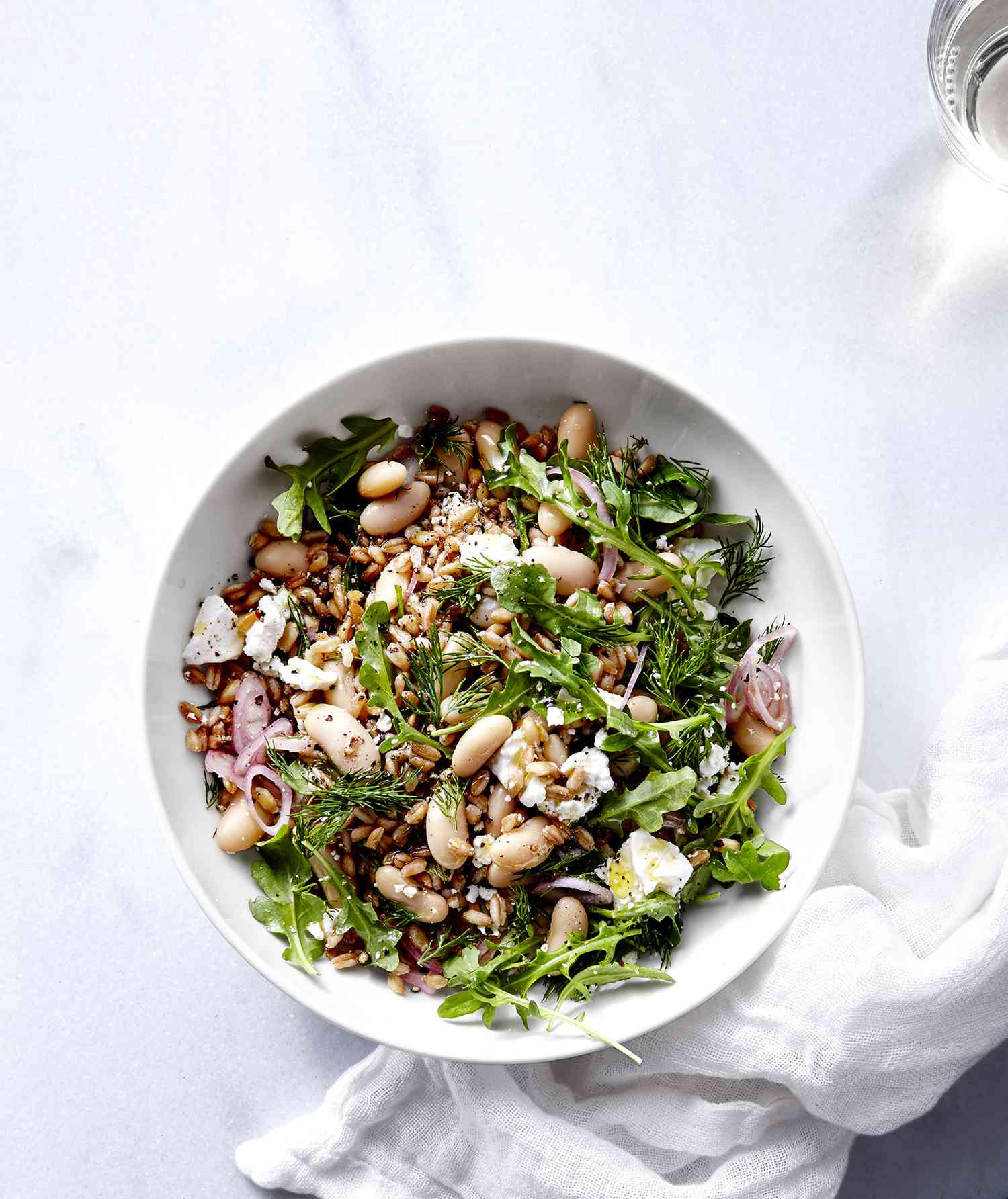 White bean and farro salad served in a white bowl.